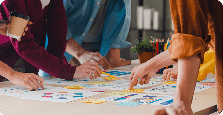 A group of people gathered around a table brainstorming