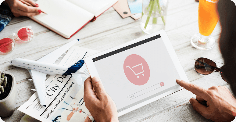Hands viewing a shopping icon on a tablet