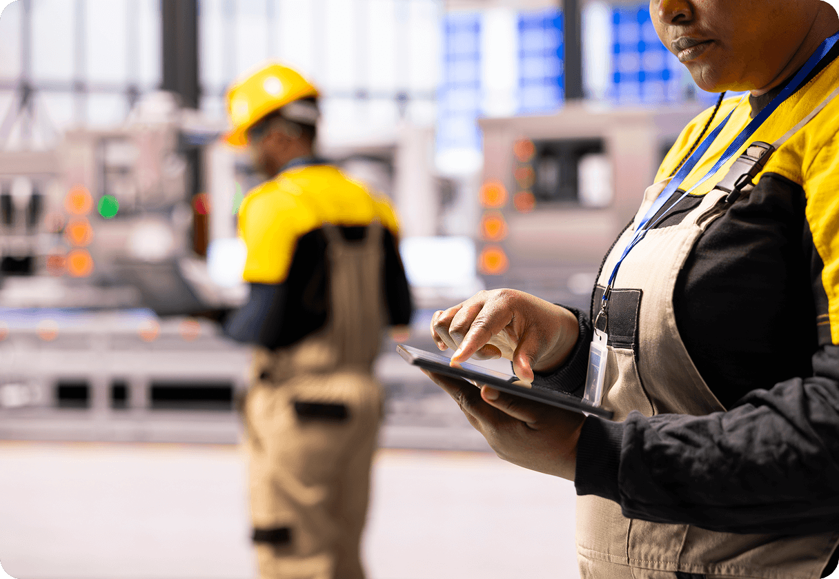 Field worker using a tablet at an industrial site