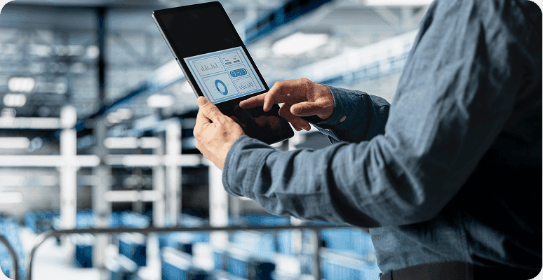 Engineer checking information on a tablet in a factory