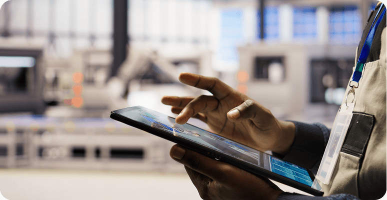 Engineer checking information on a tablet in a factory