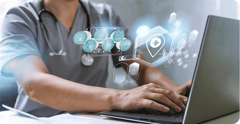 Medical professional typing on a laptop with holographic icons