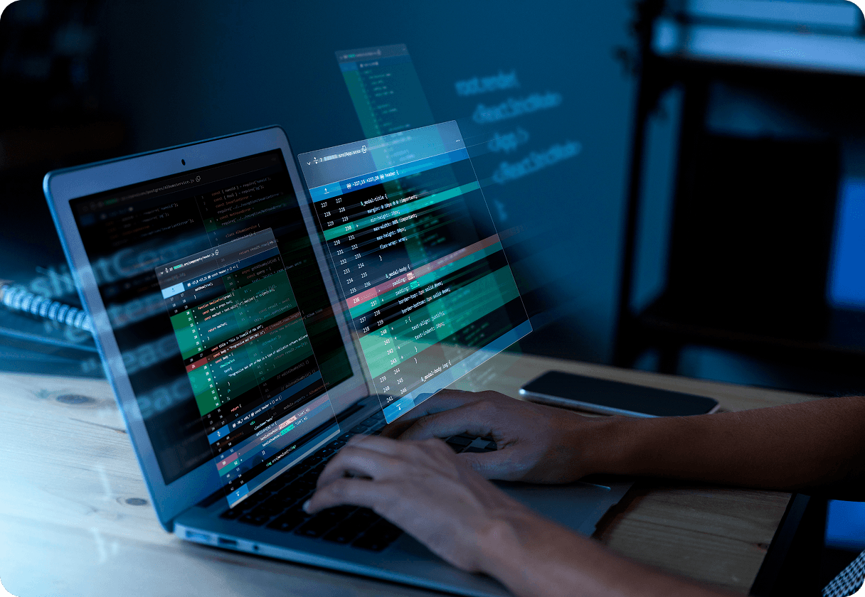 Hands typing code on a glowing laptop