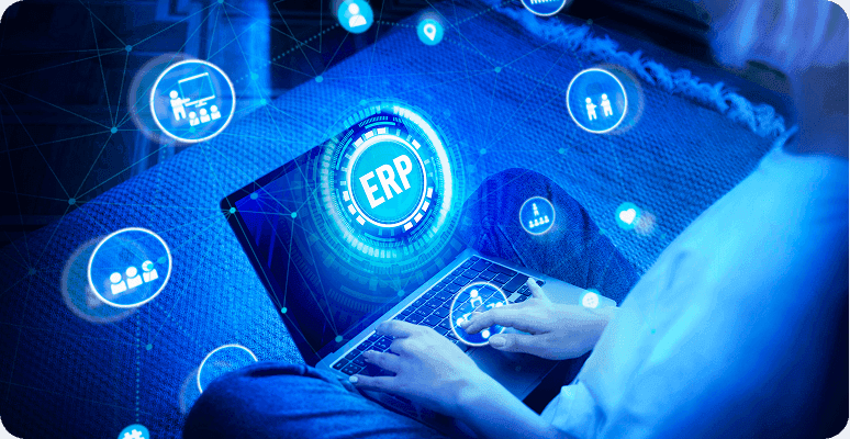Person using a laptop with a glowing "ERP" graphic overlaid