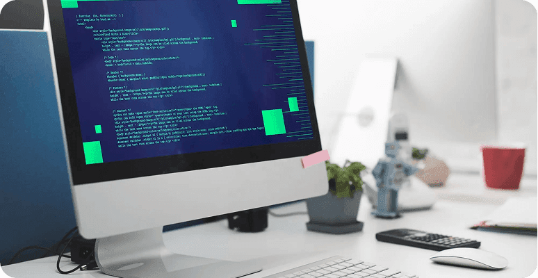 Code displayed on a desktop monitor in an office setting