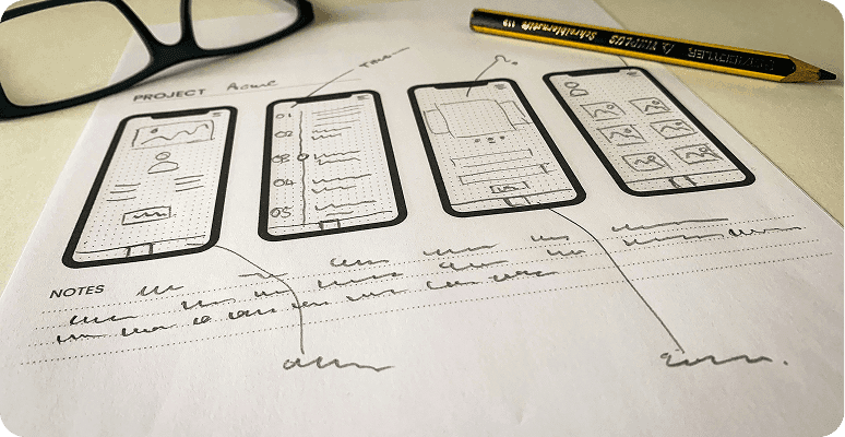 Hand-drawn paper wireframes for a mobile app project