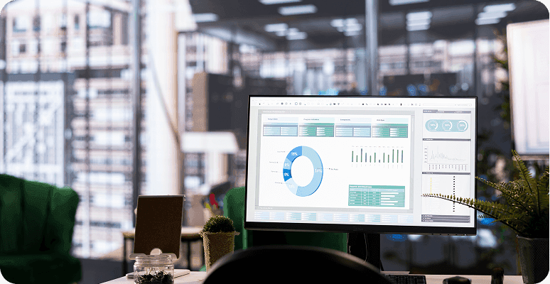 Desktop monitor showing data analytics dashboard in a modern office environment.