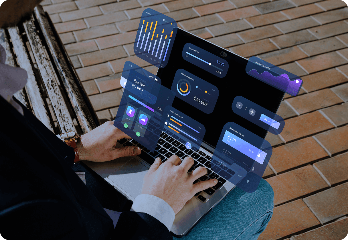 Person outside using a laptop with holographic data dashboards