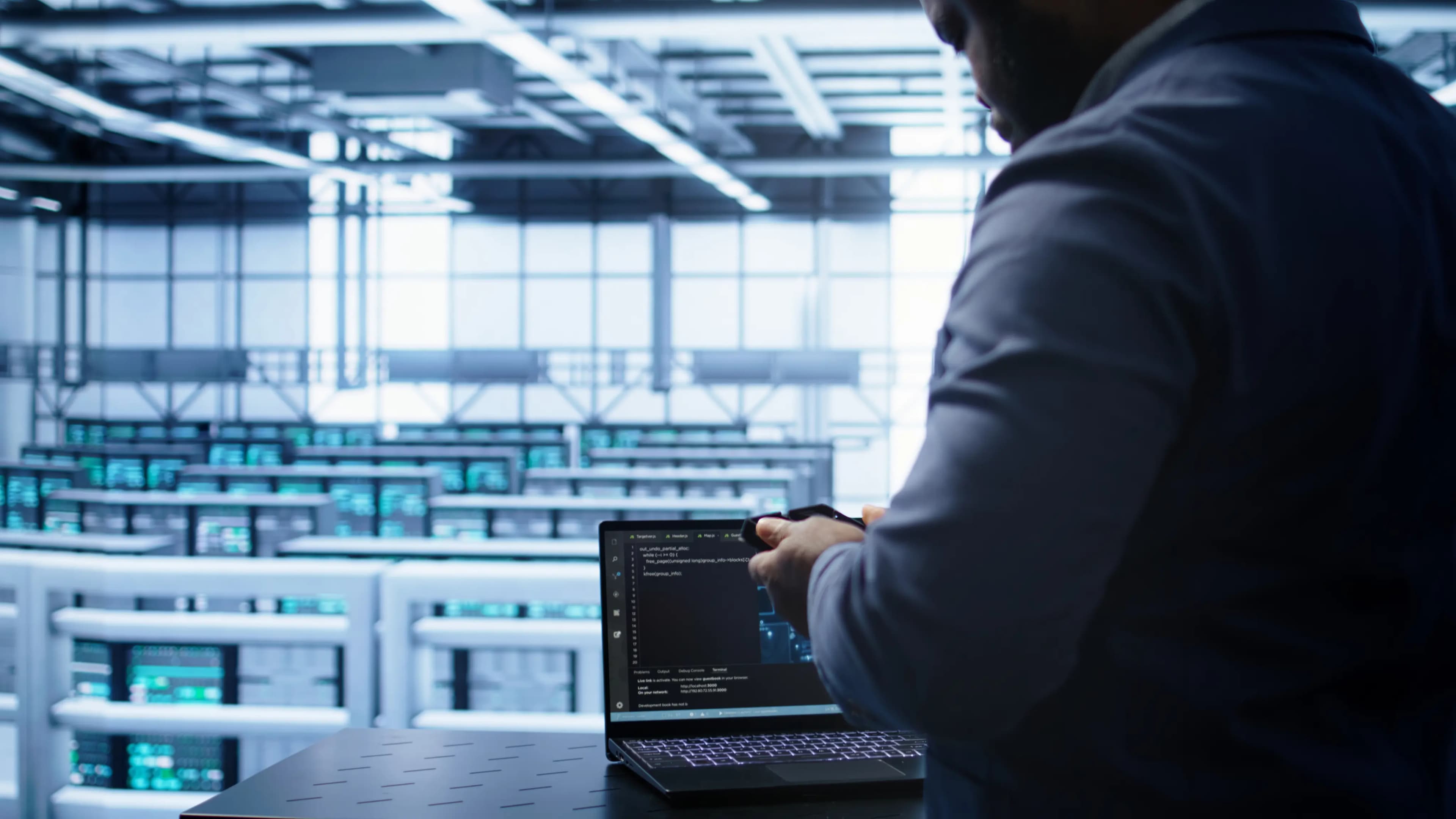 Professional working on a laptop in an industrial office